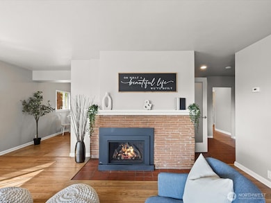 Brick flooring around hearth that extends to entry way and lower level staircase.