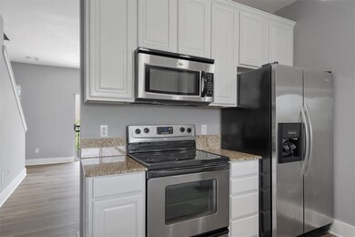 Kitchen featuring stainless steel appliances, whi
