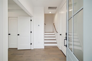 Welcoming entryway with stylish wood flooring and