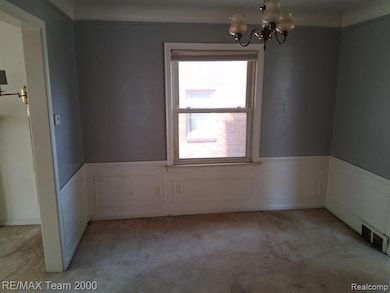 Unfurnished dining area featuring a chandelier, carpet, a decorative wall, and wainscoting
