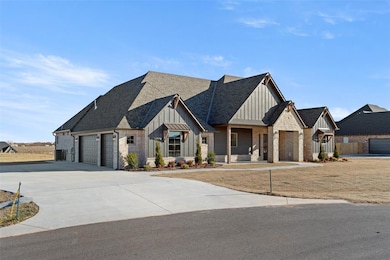 Modern farmhouse with concrete driveway, roof with