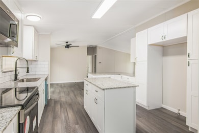 Chef's kitchen with an island and brand new cabinets proving plenty of storage