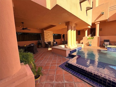 View of patio with an outdoor pool and ceiling fan