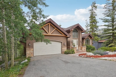 View of front of house featuring stone siding, dri
