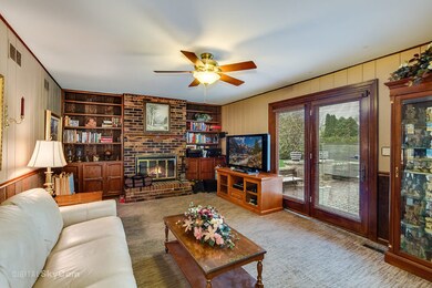 Family room with fireplace with door to paver pati