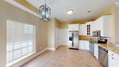 Kitchen with decorative light fixtures, stainless 