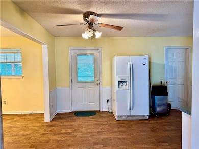 Kitchen featuring ceiling fan, wood-type flooring,