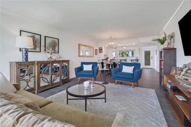 Living room with crown molding and an inviting cha