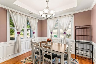 Dining room with wainscoting and engineered wood floors