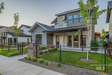 Modern home featuring covered porch, board and batten siding, a fenced front yard, and a gate