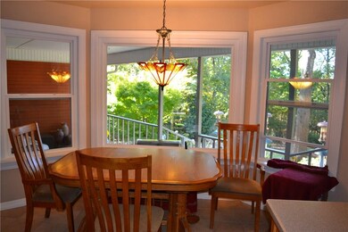 Eat-in kitchen has view of covered back porch and private backyard oasis.