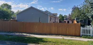 Large back yard space has garden beds on the south