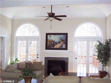 Den/Family/Great Room - Two sunny arched windows with french doors leading to a deck...
