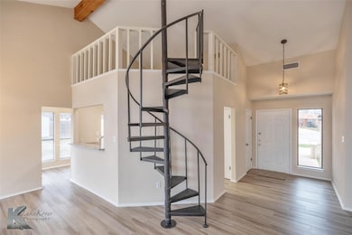 Foyer featuring high vaulted ceiling, beamed ceili