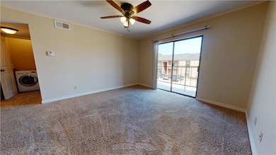 Unfurnished room featuring washer / dryer, ornamen