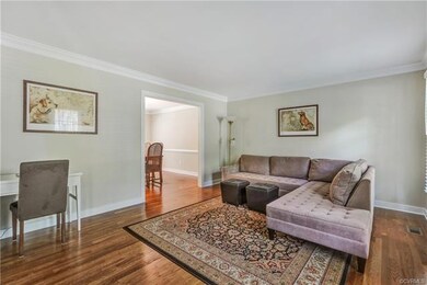 Spacious Living Room with crown molding, two windo