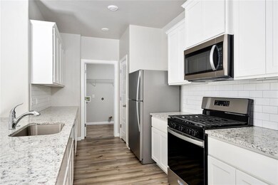 Extended counter space and stainless steel appliances make this kitchen ideal for meal prep and hosting.