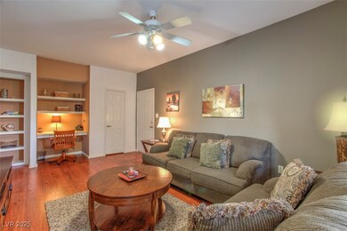 Living room featuring a ceiling fan, wood finished