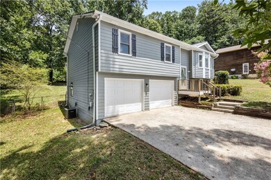 Split foyer home with driveway and an attached garage