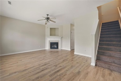 Unfurnished living room featuring ceiling fan, lig