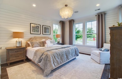 Bedroom featuring wood walls, a chandelier, light wood-type flooring, and recessed lighting