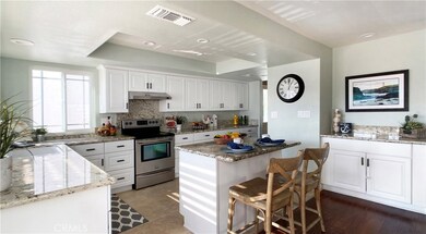 Granite Countertops & Backsplash, Center Island w/Seating, White Shaker Custom Cabinetry, Stainless Appliances, Additional Granite Buffet Counter Extending into Family Room, LED Recessed Lighting