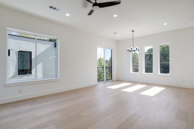 Empty room with recessed lighting, light wood-style flooring, ceiling fan, and a chandelier