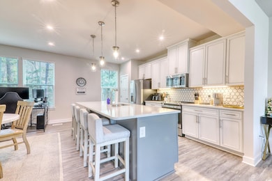 Kitchen featuring tasteful backsplash, light count