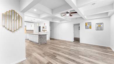 Unfurnished living room with beam ceiling, light h