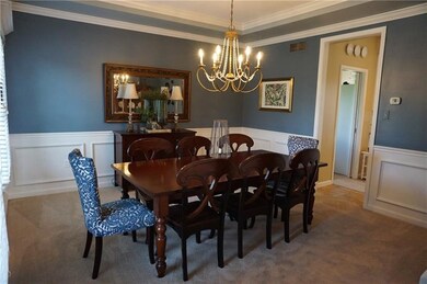 Elegant formal dinning room with wainscoting, tray
