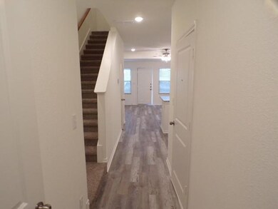 Corridor with stairs, recessed lighting, wood fini