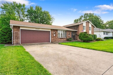 Split level home with garage and a front lawn