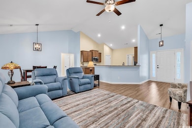Living room with wood finished floors, baseboards,