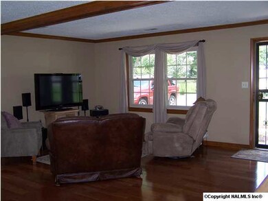 Just step inside the front door and enjoy the open living room with beautiful hardwood floors . . . .