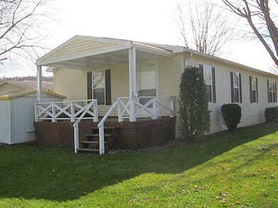 Exterior Back. Rear back porch overlooks field.