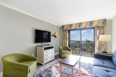 Living area with crown molding, baseboards, and a 