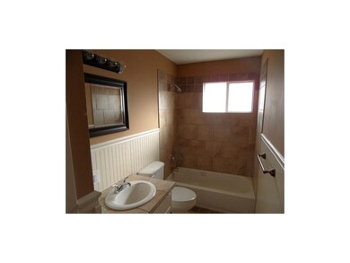Hall bath with tiled bath and floor