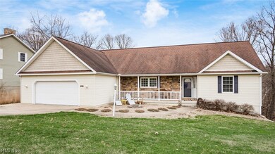 Ranch-style house with a front yard, a garage, and a porch