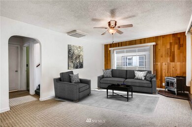 Nice sized living room with large windows and natural gas stove...virtually staged.