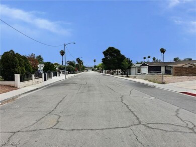 View of asphalt street featuring sidewalks, curbs,