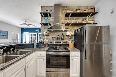 Kitchen featuring ceiling fan, island range hood, 