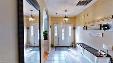 Light-filled entry way, with arched doorway into office.