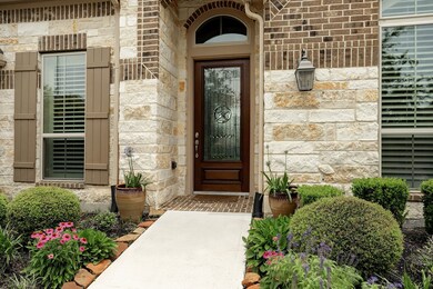 Enter your home through this pretty walkway and front entrance.