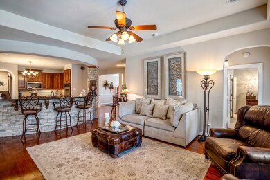 Beautiful wood floors enhance the living room, with intricate details everywhere you look.