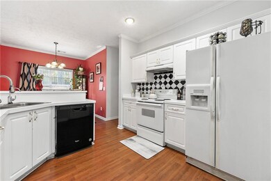 Kitchen with white cabinets, a sink, a notable cha