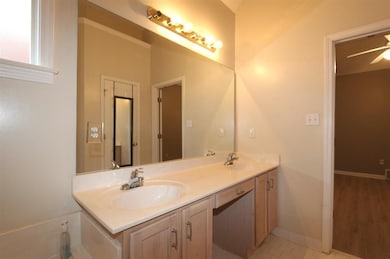 Bathroom featuring double vanity, baseboards, a si