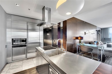 Kitchen featuring island exhaust hood, stainless s