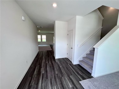 Hall with wood finished floors, baseboards, recessed lighting, and stairs