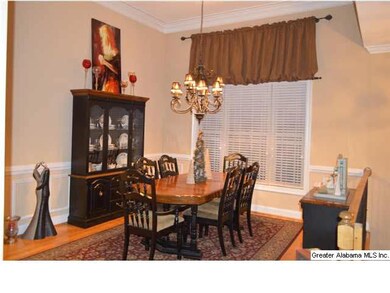 Vaulted ceiling, gorgeous lighting and hardwoods adorn this dining room.