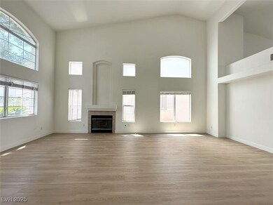 Unfurnished living room featuring high vaulted cei